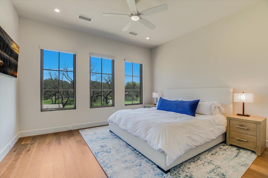 Bedroom with a ceiling fan, light wood-style floors, and recessed lighting