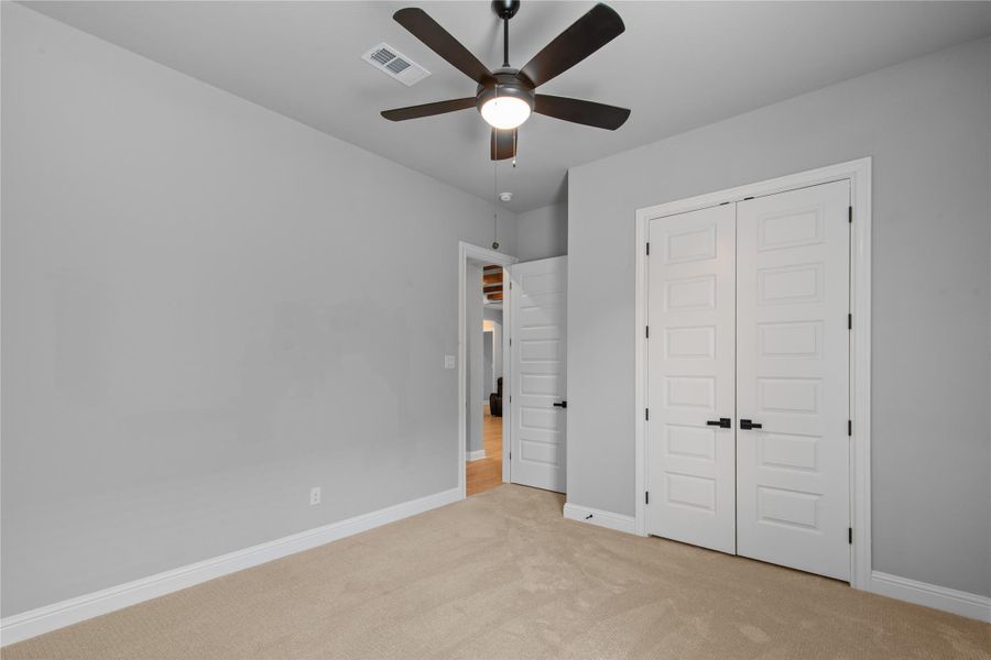 Serene bedroom with attached bath, featuring modern fixtures and ample natural light.