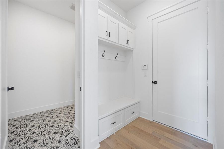 Mudroom with baseboards and light wood-type flooring Mudroom with baseboards and light wood-type flooring