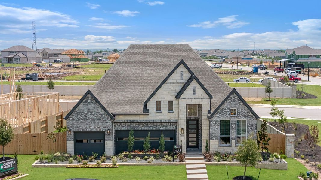 Front exterior of a new home in The Grove at Blackhawk, Pflugerville, TX, highlighting curb appeal (Image 25). Front exterior of a new home in The Grove at Blackhawk, Pflugerville, TX, highlighting curb appeal (Image 25).