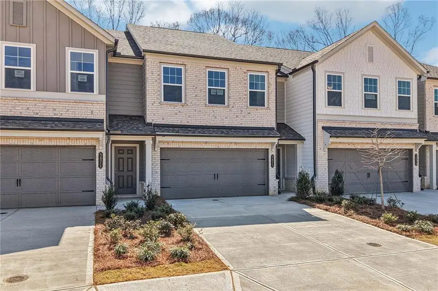 Front exterior of a new home in Eastlyn Crossing, Flowery Branch, GA, highlighting curb appeal (Image 2). Front exterior of a new home in Eastlyn Crossing, Flowery Branch, GA, highlighting curb appeal (Image 2).
