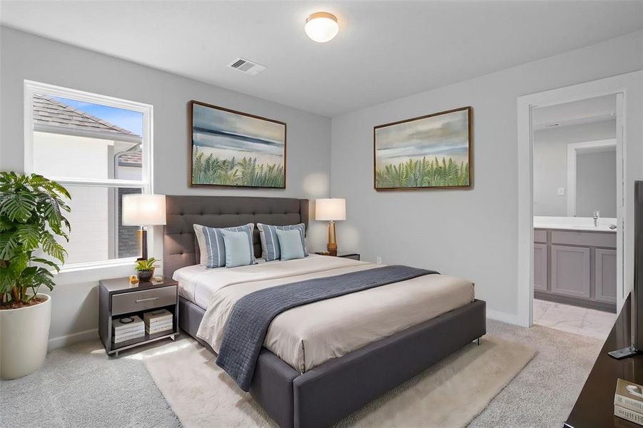 Secondary bedroom features plush carpet, custom paint, high ceilings, private bath, and a large window with privacy blinds.