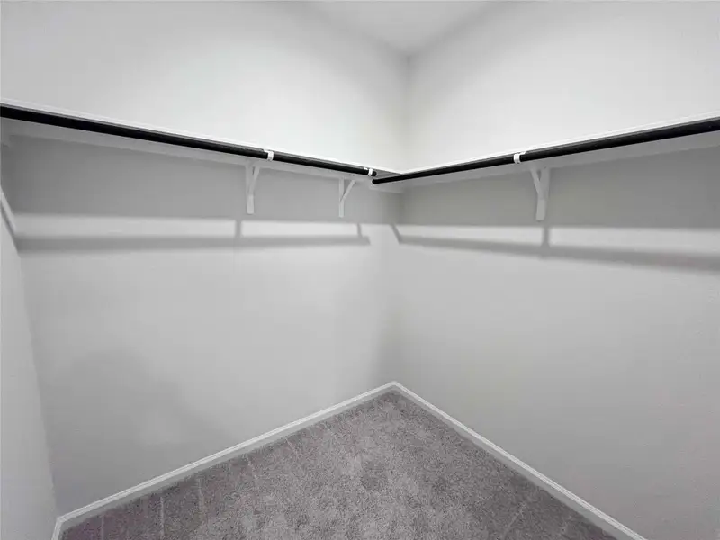 The Robin II- Primary Walk-in Closet. Home under construction. Sample floor plan photo used for illustrative purposes only. Upgrades, selections options, windows and colors may vary. The Robin II- Primary Walk-in Closet. Home under construction. Sample floor plan photo used for illustrative purposes only. Upgrades, selections options, windows and colors may vary.