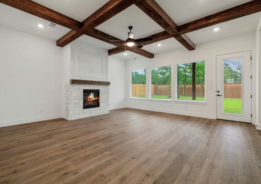 Living room with beam accents and a fireplace. Living room with beam accents and a fireplace.