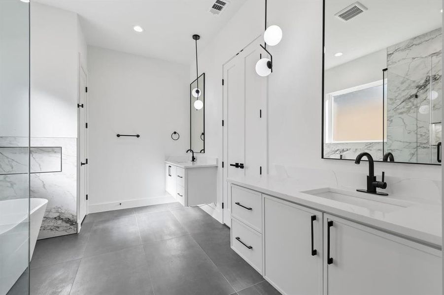 Full bath with two vanities, a freestanding tub, a marble finish shower, and recessed lighting Full bath with two vanities, a freestanding tub, a marble finish shower, and recessed lighting