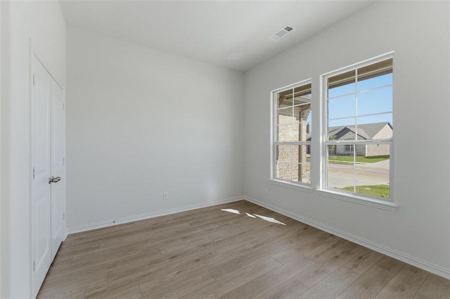 Empty room with light wood-style flooring and baseboards