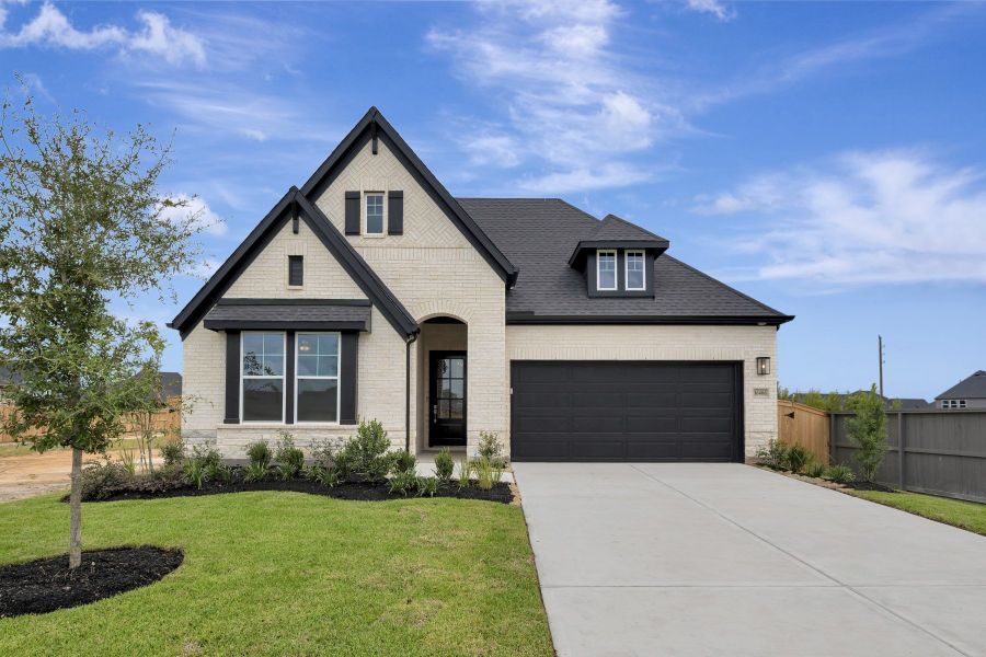 Front exterior of a new home in The Grand Prairie - Retreat Collection, Hockley, TX, highlighting curb appeal (Image 18). Front exterior of a new home in The Grand Prairie - Retreat Collection, Hockley, TX, highlighting curb appeal (Image 18).