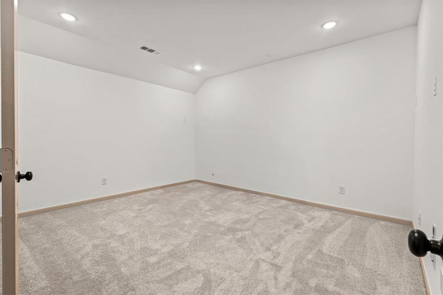 Unfurnished room with carpet floors, recessed lighting, and vaulted ceiling