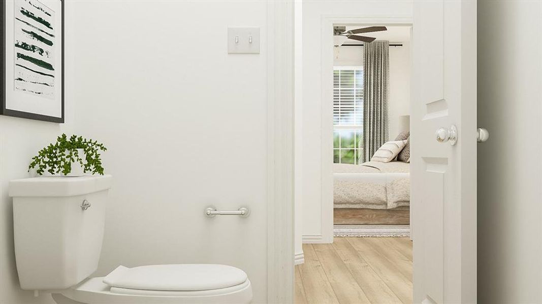 Bathroom featuring hardwood / wood-style floors, toilet, and ceiling fan