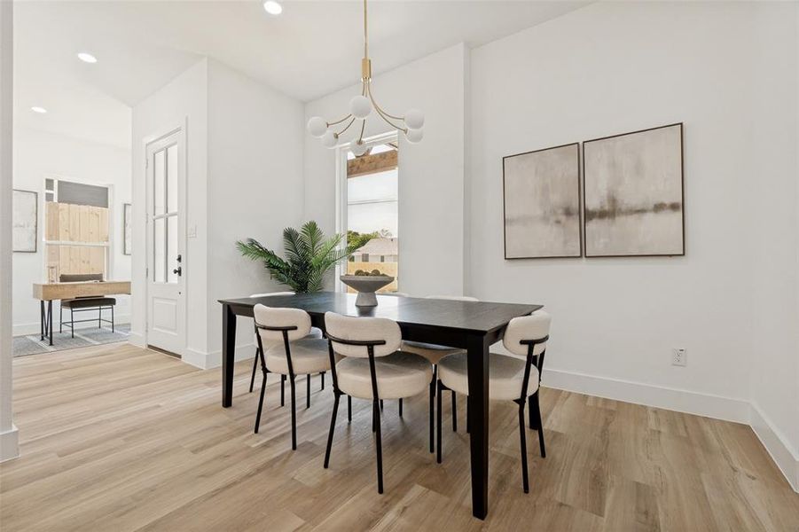 Spacious room featuring light wood-finish flooring, white baseboards, and bright recessed lighting Spacious room featuring light wood-finish flooring, white baseboards, and bright recessed lighting