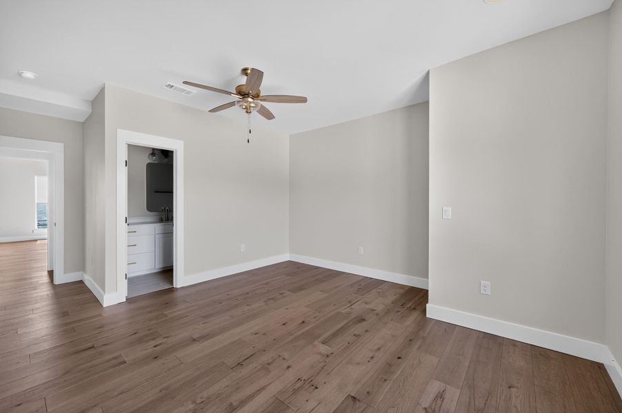 Rich hardwood flooring complements the crisp white trim of this versatile room.