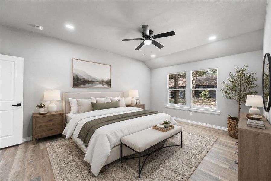 Spacious room featuring vaulted ceilings, wood-finish flooring, recessed lighting, and a contemporary ceiling fan Spacious room featuring vaulted ceilings, wood-finish flooring, recessed lighting, and a contemporary ceiling fan