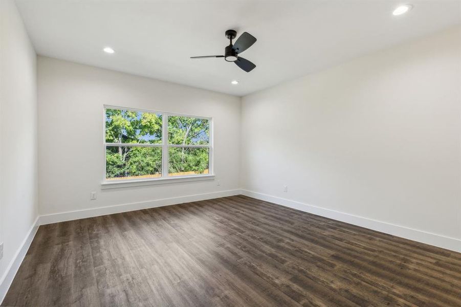 Light bathed Primary bedroom with views to the back yard