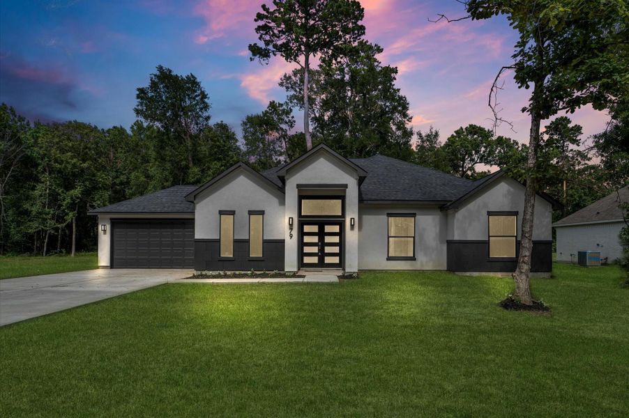 Modern single-story home with a sleek design, featuring a dark roof and contrasting light exterior. The property is surrounded by lush greenery, with a spacious driveway leading to a two-car garage. Ideal for those seeking a blend of style and nature. Modern single-story home with a sleek design, featuring a dark roof and contrasting light exterior. The property is surrounded by lush greenery, with a spacious driveway leading to a two-car garage. Ideal for those seeking a blend of style and nature.