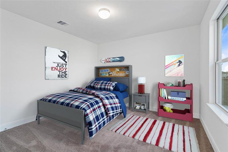 Secondary bedroom features plush carpet, neutral paint, lighting, windows and ample sized closet space.