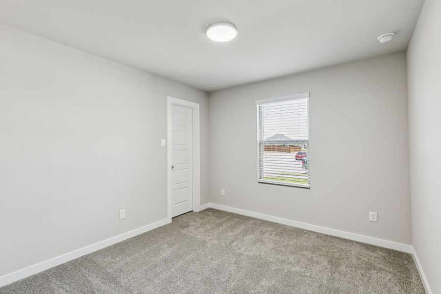 Bedroom in the Harper home plan by Trophy Signature Homes – REPRESENTATIVE PHOTO