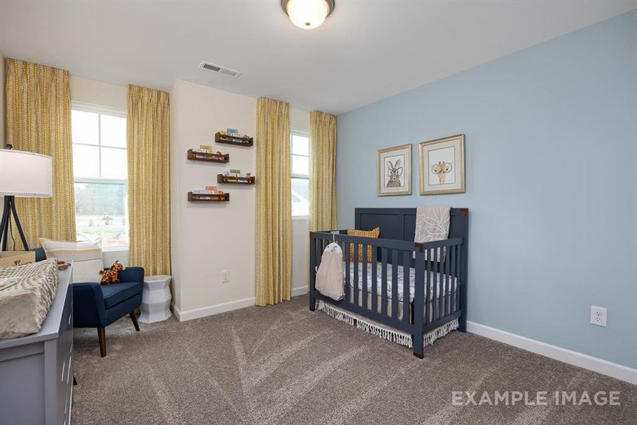 Carpeted bedroom with a nursery area