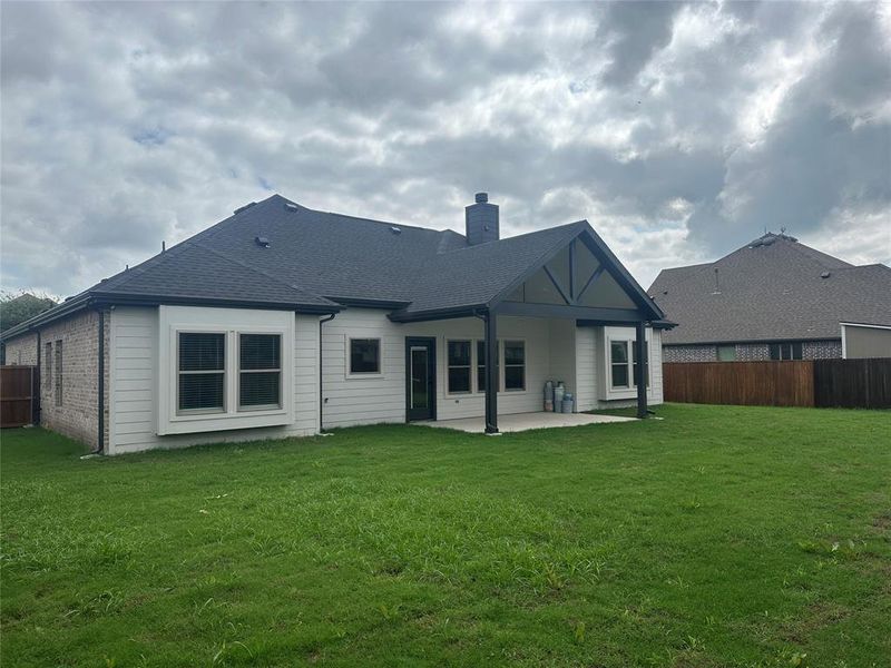 Back of property with a patio and a yard