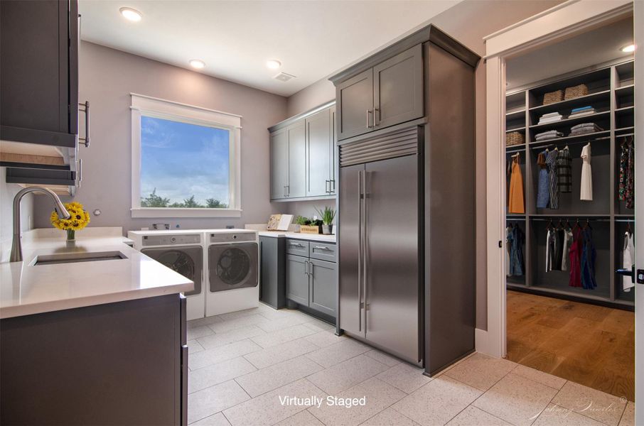 Laundry Room with space for a refrigerator or freezer and easy access to the primary closet. there is plenty of storage in the cabinetry and lots of natural lighting from the large window. Laundry Room with space for a refrigerator or freezer and easy access to the primary closet. there is plenty of storage in the cabinetry and lots of natural lighting from the large window.