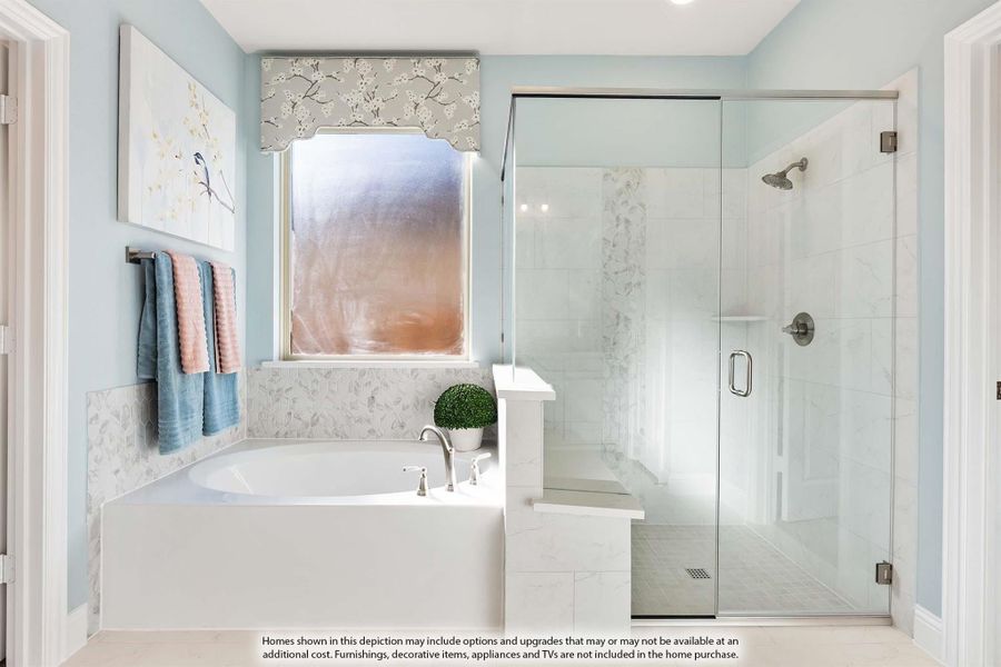 Bathroom with soaking tub, glass-enclosed walk-in shower, marble tile walls, and light blue painted walls