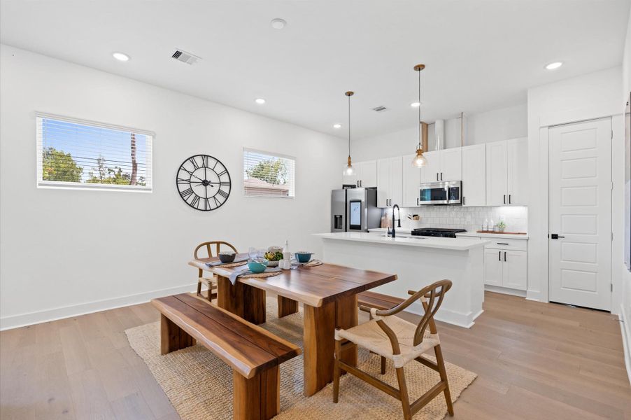 The open layout connects effortlessly to the kitchen, where a stylish island doubles as a dining space. High ceilings and strategically placed lighting enhance the airy feel, making the space ideal for both relaxation and entertaining. The open layout connects effortlessly to the kitchen, where a stylish island doubles as a dining space. High ceilings and strategically placed lighting enhance the airy feel, making the space ideal for both relaxation and entertaining.