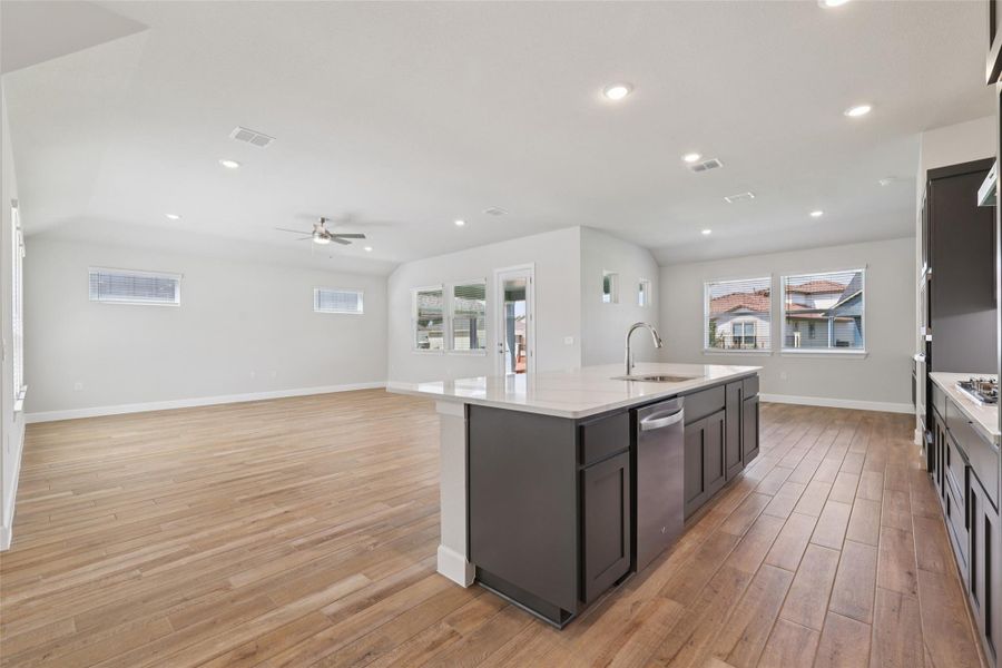 Kitchen with light wood-style floors, a kitchen island with sink, ceiling fan, stainless steel appliances, and recessed lighting