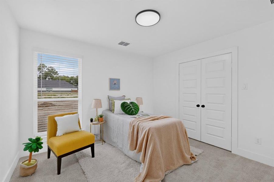 Bright room with neutral wall paint and carpeting, featuring a window with blinds, a flush mount ceiling light, and double panel doors with dark hardware
