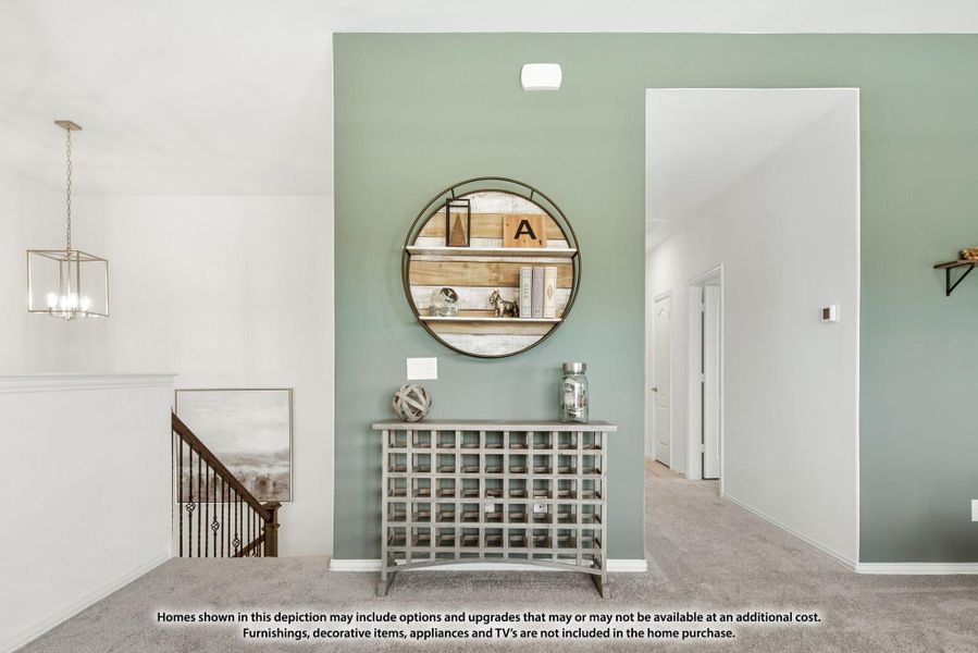 Entryway with sage green accent wall, round mirror, console table, and pendant light near staircase Entryway with sage green accent wall, round mirror, console table, and pendant light near staircase