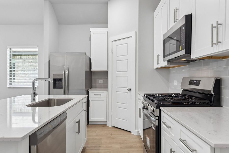 Kitchen in the Cypress home plan by Trophy Signature Homes - REPRESENTATIVE PHOTO
