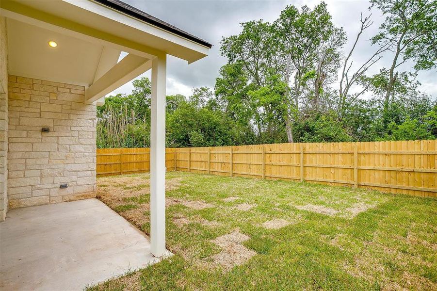 View of yard featuring a patio and a fenced backyard View of yard featuring a patio and a fenced backyard