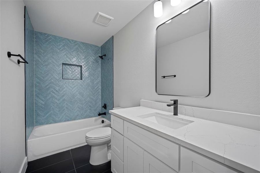 Full bathroom with visible vents, toilet, tile patterned flooring, tub / shower combination, and vanity