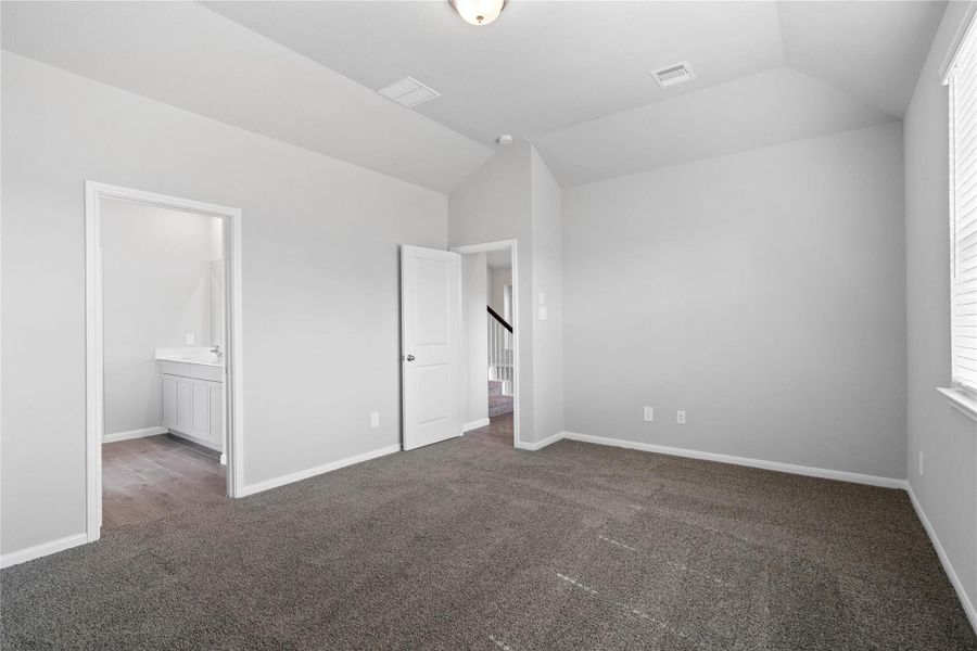 The private primary suite efficiently connects the sleeping area with the dedicated bathroom and generous closet.