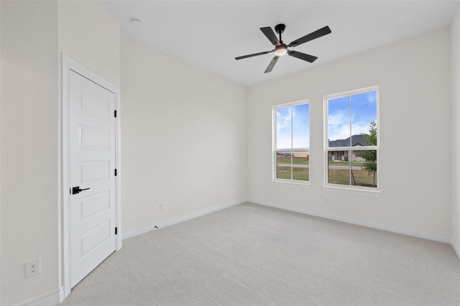 Spare room featuring light carpet and a ceiling fan Spare room featuring light carpet and a ceiling fan