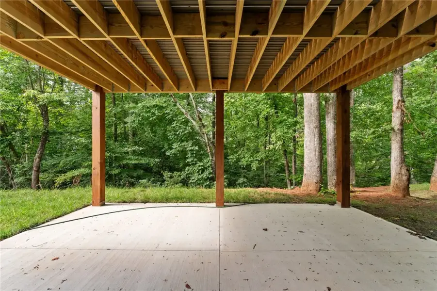 A sheltered concrete patio features stout support A sheltered concrete patio features stout support