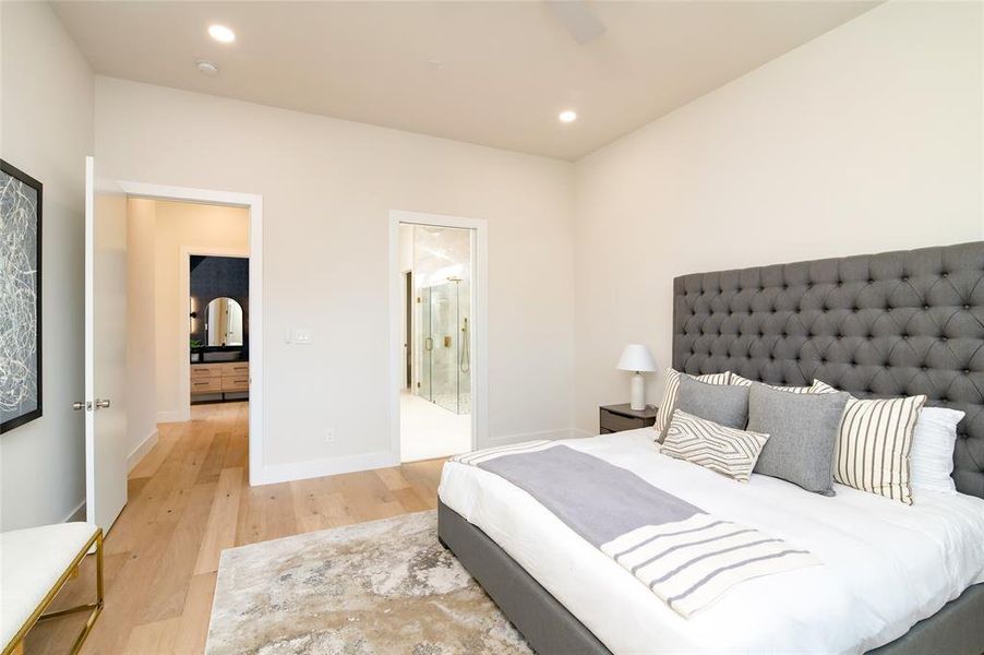 Bedroom featuring light wood-type flooring and ensuite bathroom