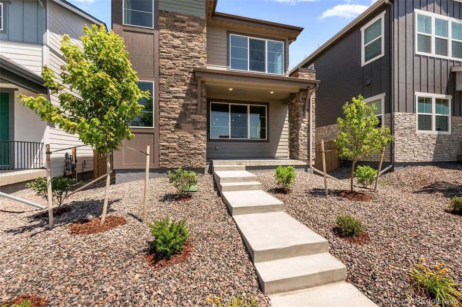 Front exterior of a new home in Painted Prairie, Aurora, CO, highlighting curb appeal (Image 29).