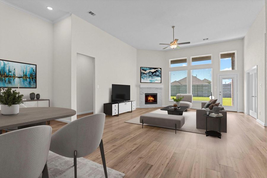 Open family room with wood-look flooring, cozy corner gas fireplace, and a wall of windows overlooking the backyard for natural light.  The beautiful flooring will lead to a private tucked away primary suite! *Virtually Staged*
