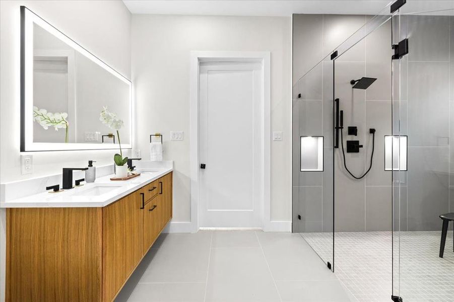 Bathroom with vanity, a shower with door, and tile patterned flooring