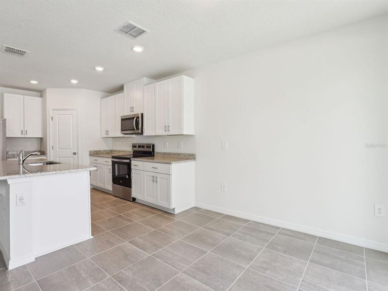 Furnished interior view inside a new home in The Reserve at Van Oaks, Auburndale (Image 11).