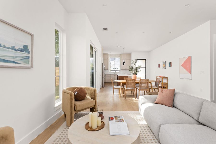 Living room featuring light wood-type flooring and baseboards Living room featuring light wood-type flooring and baseboards