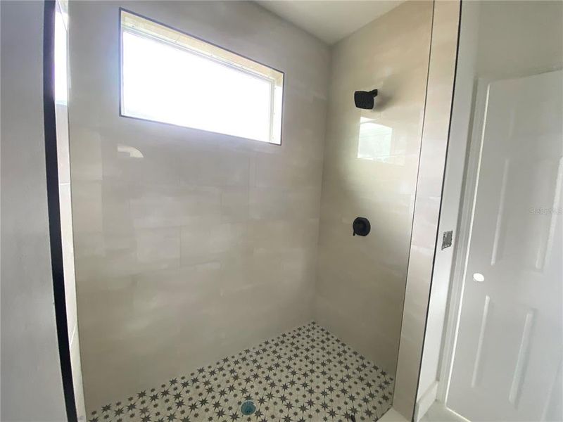 master bath with tiled walk-in shower
