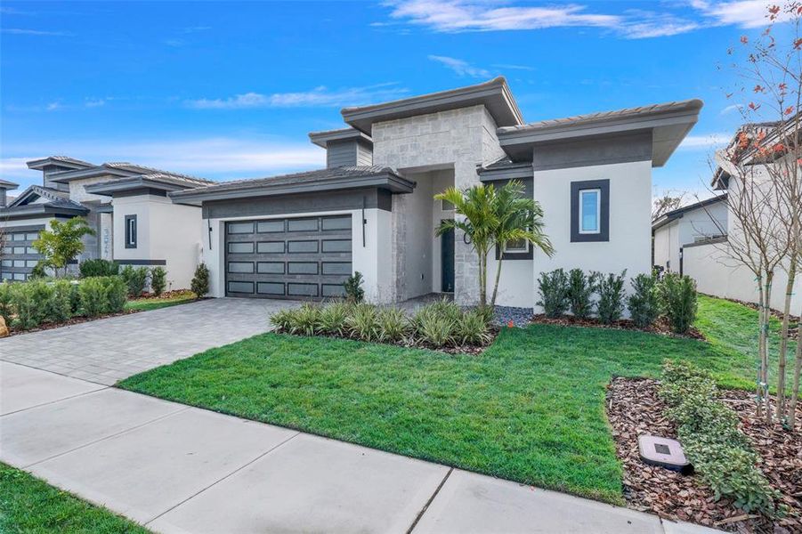 Front exterior of a new home in Hampton Green at Providence, Davenport, FL, highlighting curb appeal (Image 28).