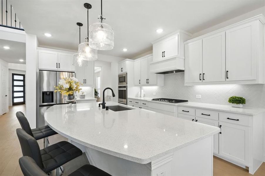 Sparkling quartz counters and custom cabinets.