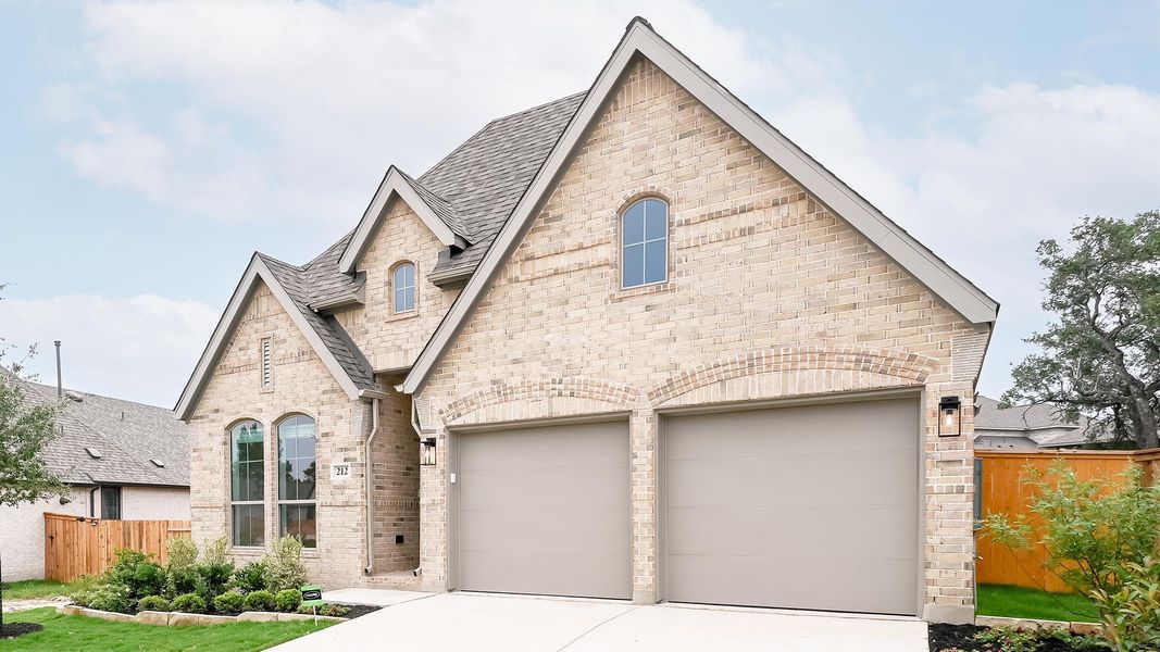 Front exterior of a new home in 6 Creeks, Kyle, TX, highlighting curb appeal (Image 2).