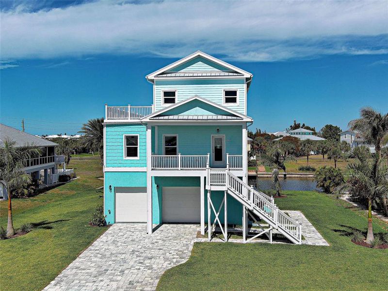 Front exterior of a new home in , Placida, FL, highlighting curb appeal (Image 2). Front exterior of a new home in , Placida, FL, highlighting curb appeal (Image 2).