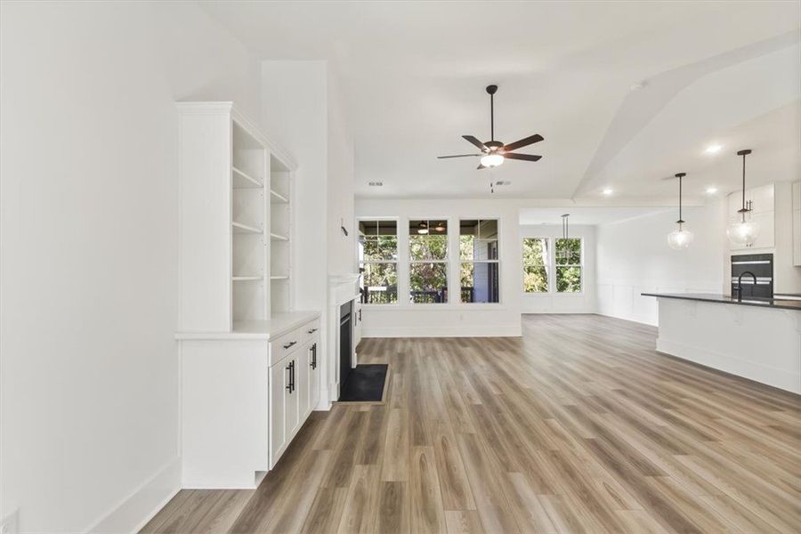 Gleaming wood look flooring complements the airy,