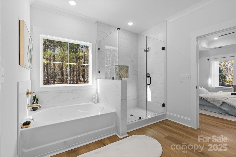 *representative photo- primary ensuite full bath w/ tub, frameless custom tiled shower, separate commode room