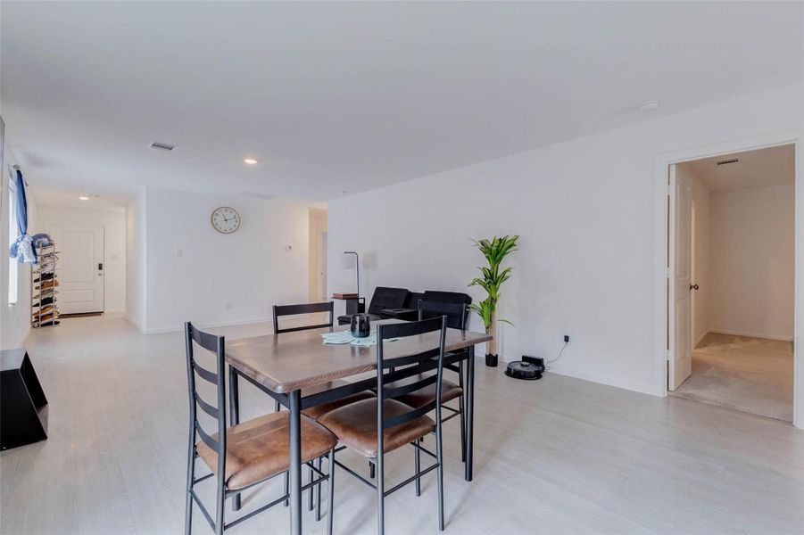Dining area conveniently located between the kitchen and living room with an open-concept layout.