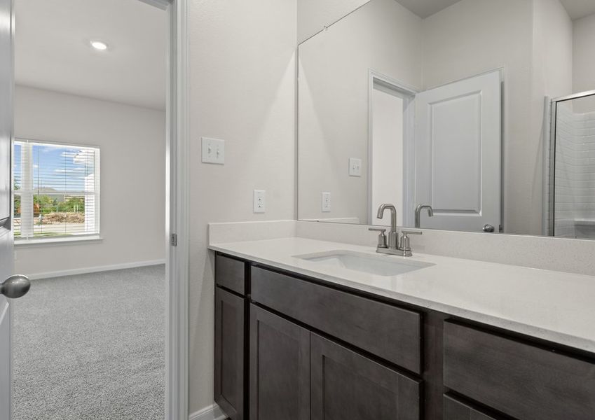 The master bathroom has a sprawling vanity.
