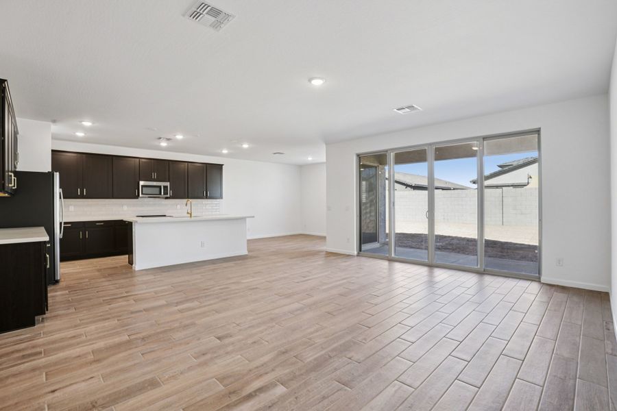 Great room & Kitchen - Stonebridge Model Home. Finishes and options may vary by community